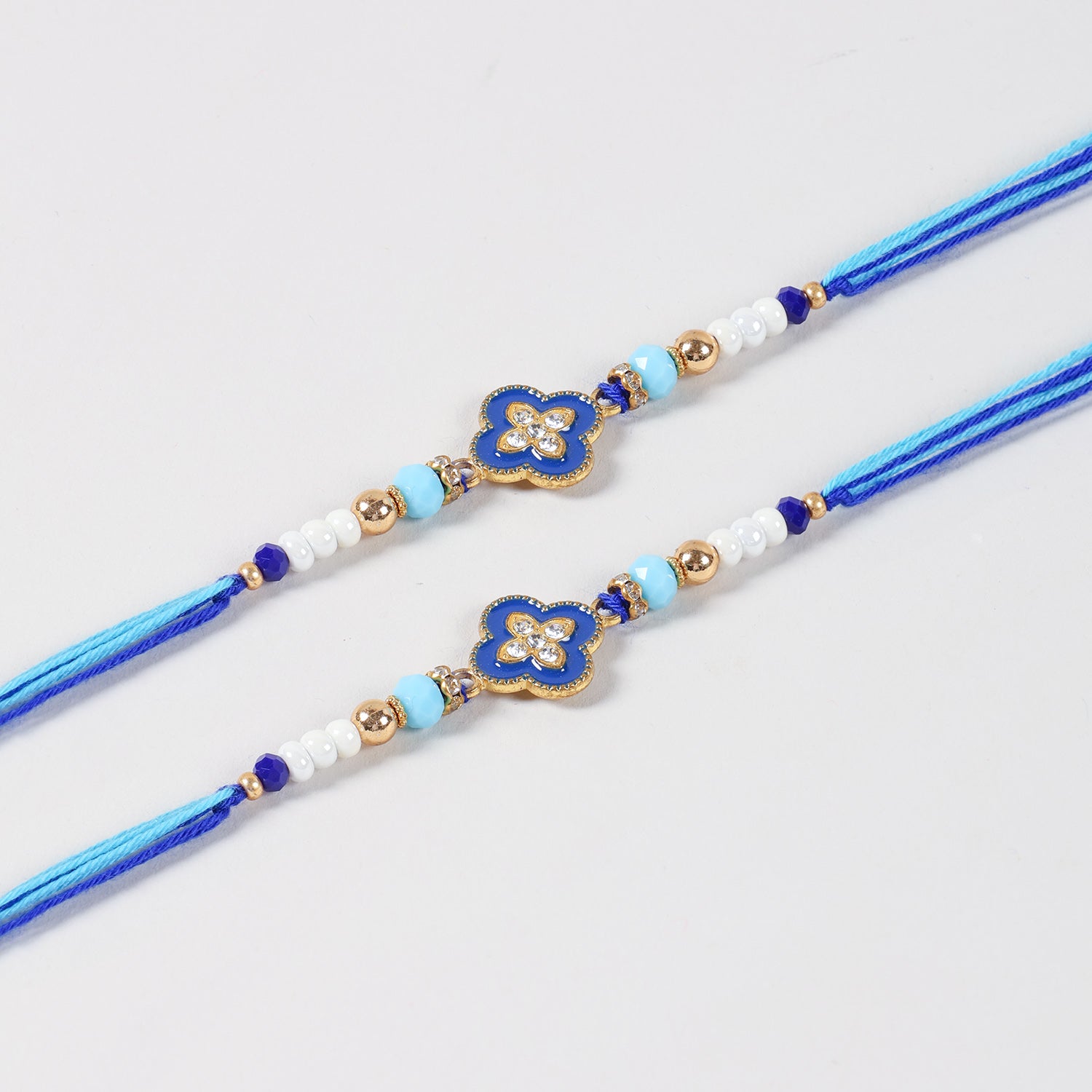 Close-up of the Handmade Metal Floral Rakhi featuring an elegant floral charm, decorative beads, and handcrafted details.