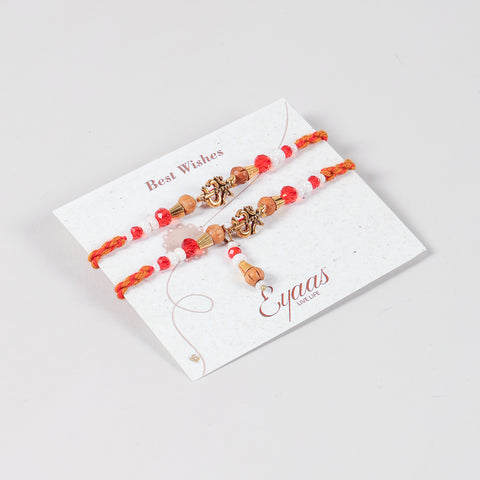 Angled view of the Handmade Om Rakhi & Lumba Set attached to a Best Wishes greeting card for Raksha Bandhan gifting.