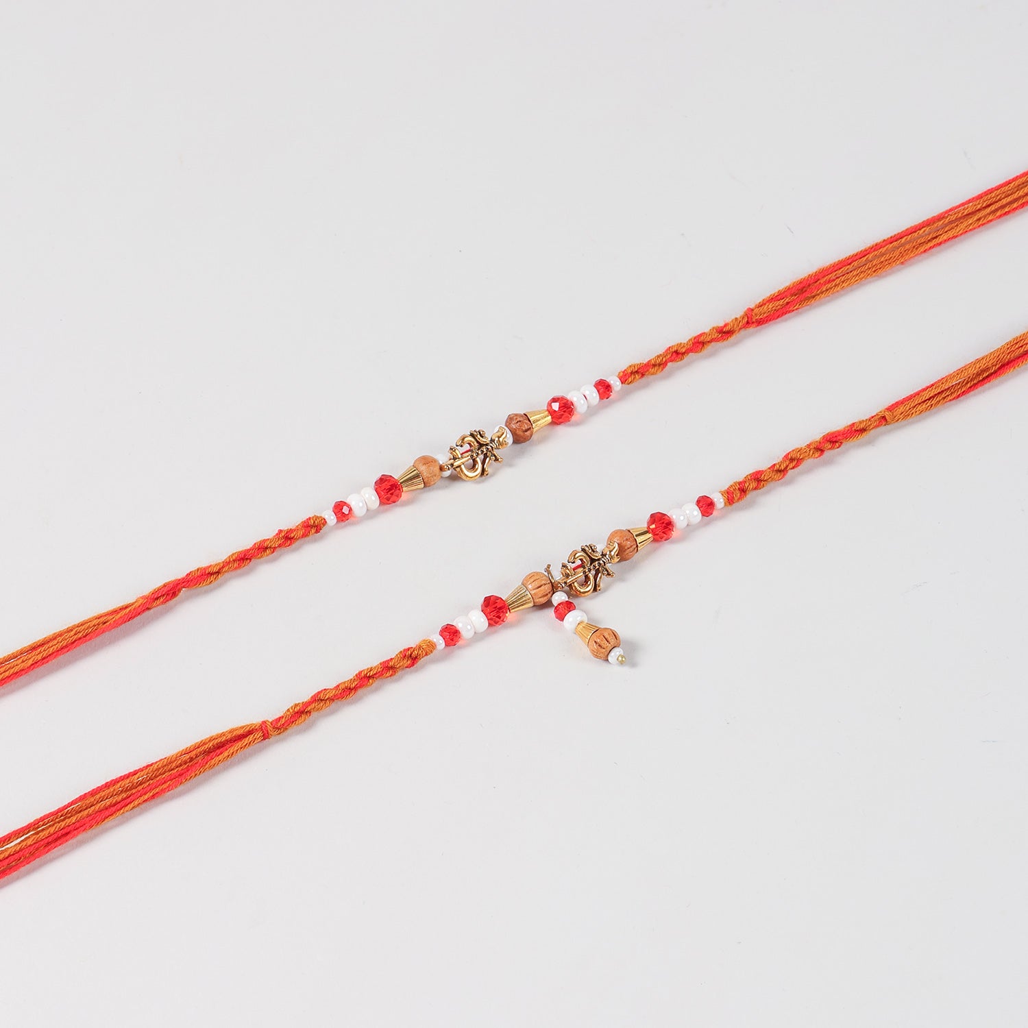 Close-up of the Handmade Om Rakhi & Lumba Set featuring the Om charm, handcrafted beadwork, and traditional thread detailing.
