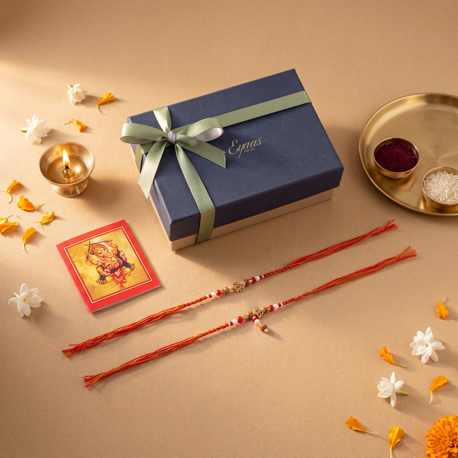 Handmade Om Rakhi and Lumba Set for Bhaiya Bhabhi presented in a luxury blue gift box for Raksha Bandhan gifting