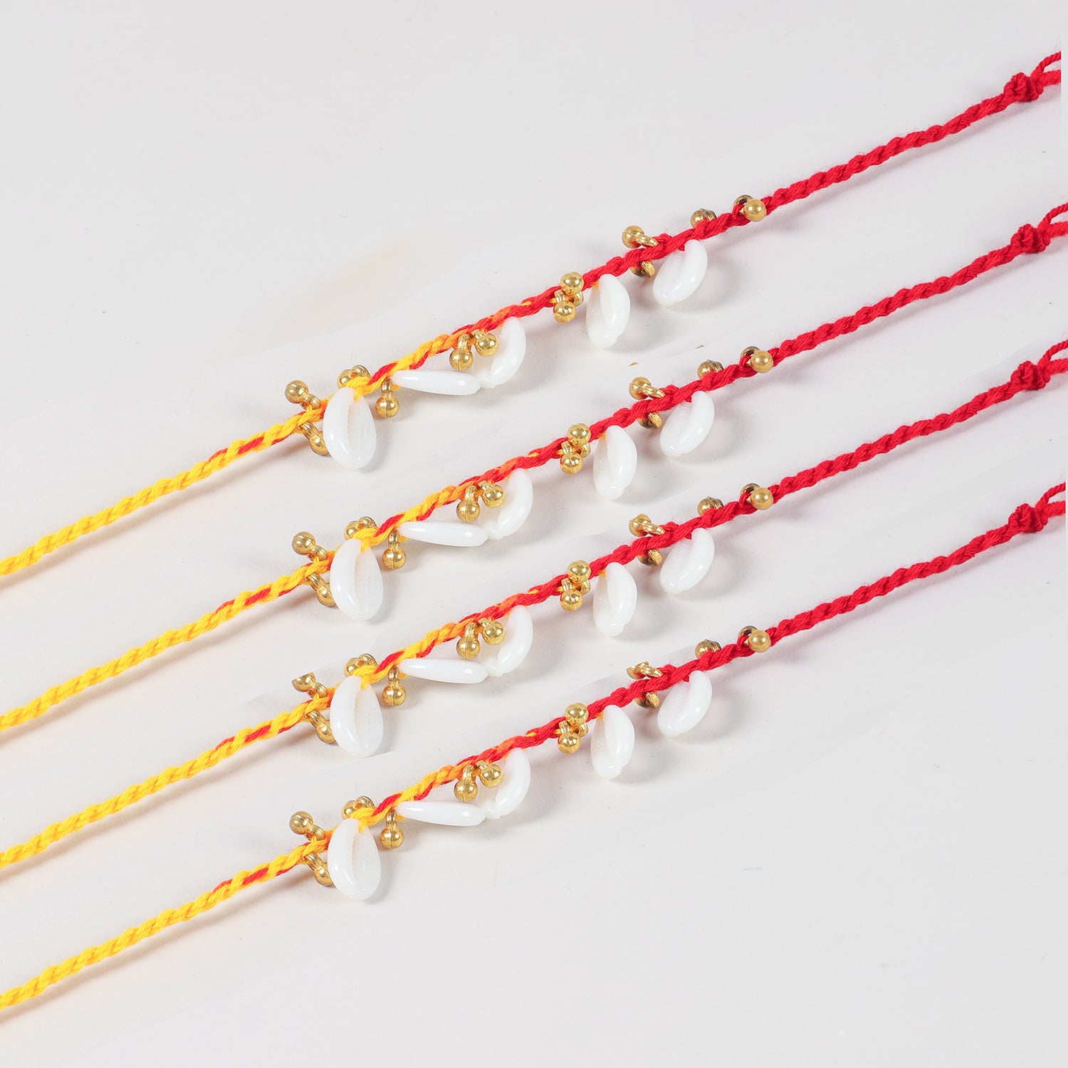 Close-up of the Handmade Sea Shells & Ghungroo Rakhi featuring natural sea shells, golden ghungroos, and handcrafted detailing