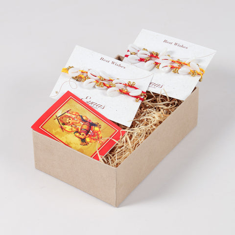 Handmade Sea Shells & Ghungroo Rakhi Set of 4 neatly arranged inside a decorative Raksha Bandhan gift box.