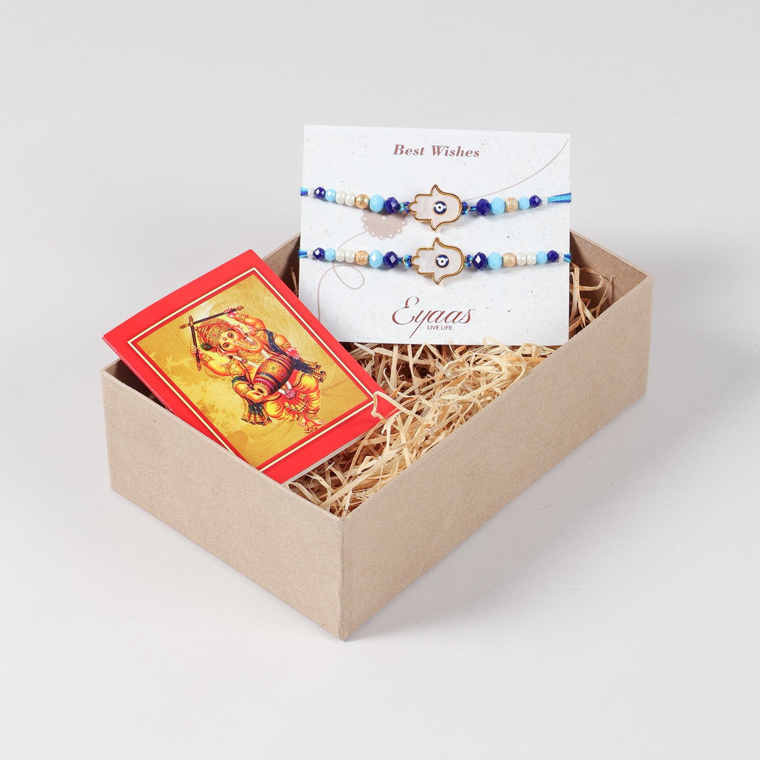 Handmade White Hamsa Evil Eye Rakhi Set of 2, carefully arranged inside a festive Raksha Bandhan gift box