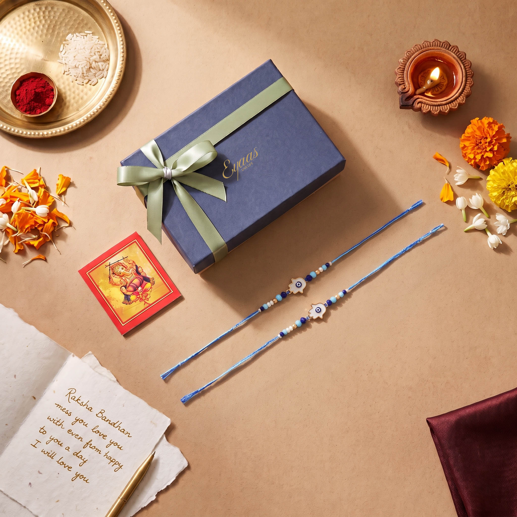 Handmade White Hamsa Hand  Evil Eye Rakhi Set of 2, beautifully presented in a festive gift box, ready for Raksha Bandhan gifting.e