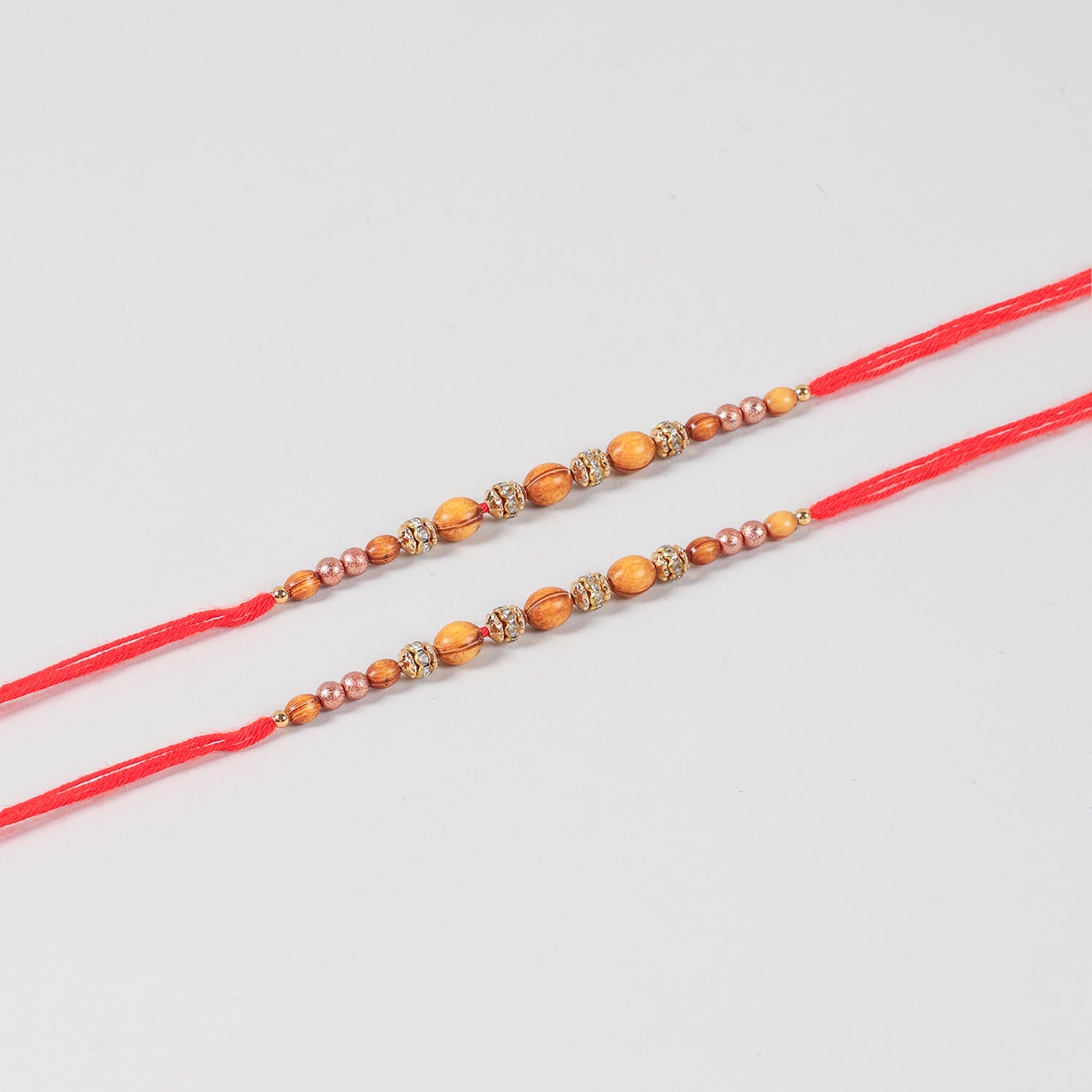 Close-up of the Handmade Wooden & Glass Beads Rakhi featuring natural wooden beads, glass beads, stone spacers, and traditional Mauli thread.