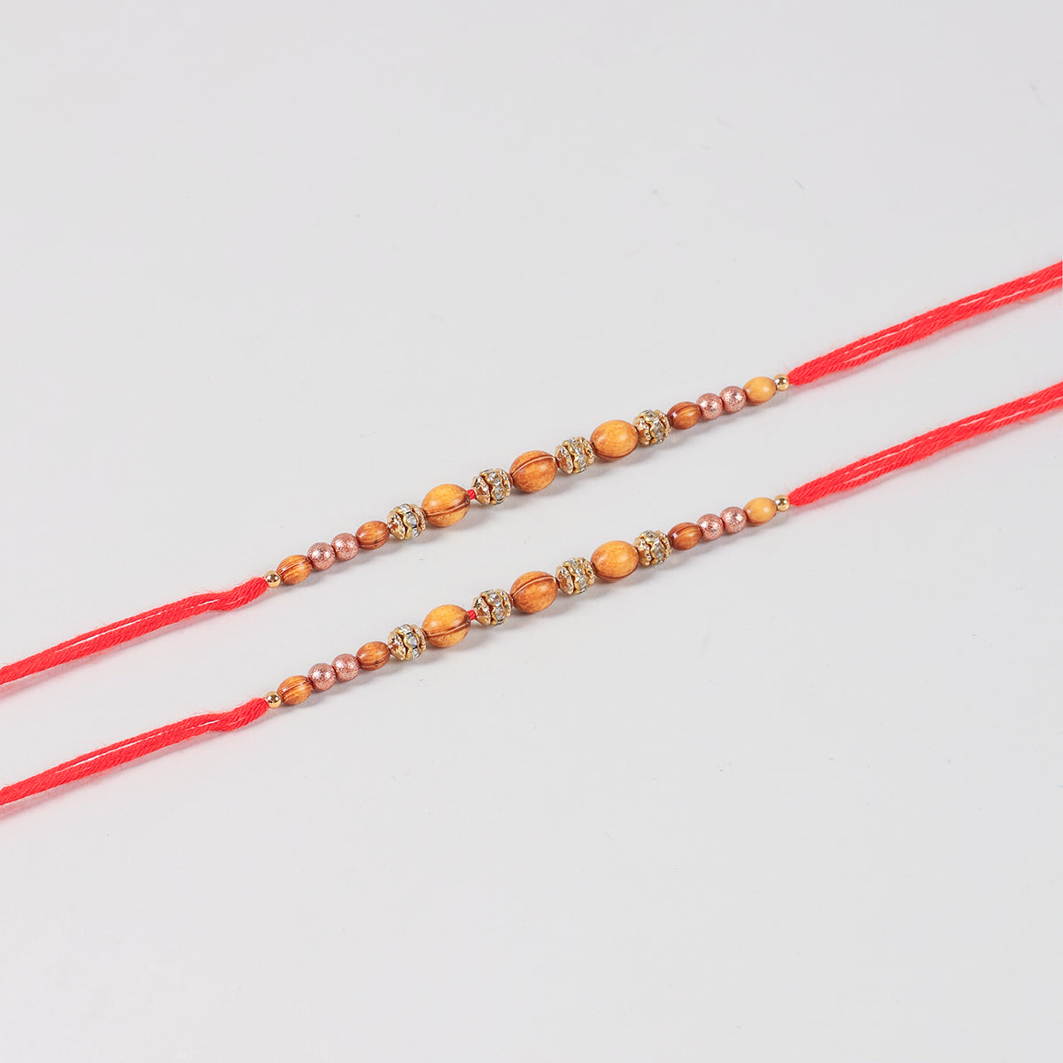 Close-up of the Handmade Wooden & Glass Beads Rakhi featuring natural wooden beads, glass beads, stone spacers, and traditional Mauli thread.