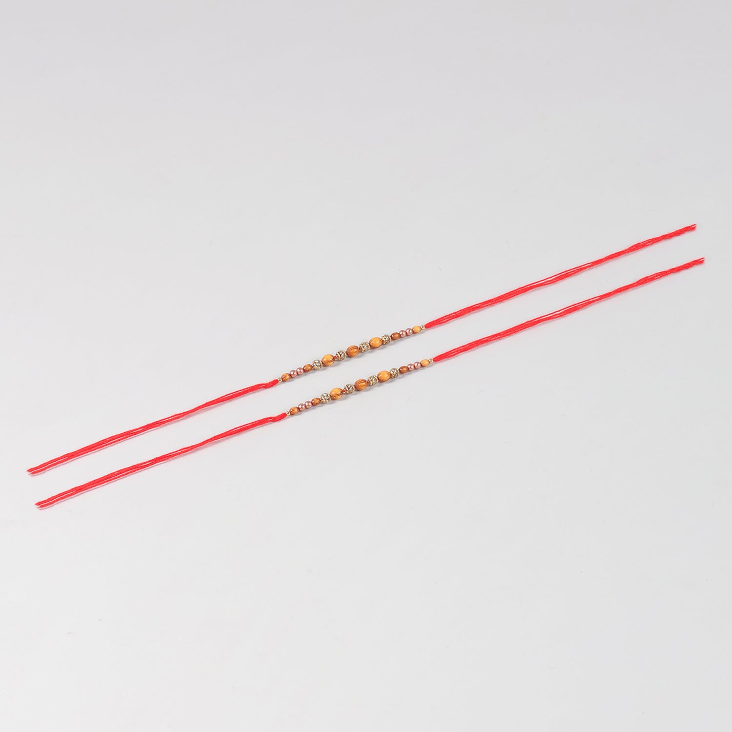 Full-length view of the Handmade Wooden & Glass Beads Rakhi Set of 2 showing handcrafted beadwork and festive Mauli thread.
