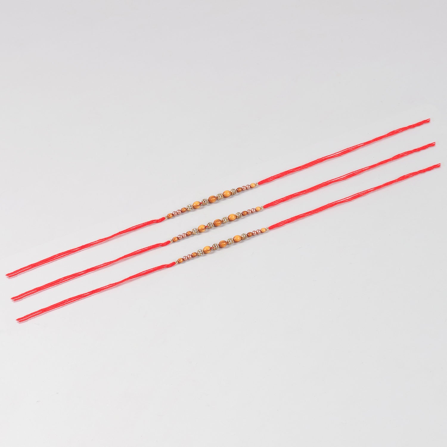 Full-length view of the Handmade Wooden & Glass Beads Rakhi Set of 3 with complete handcrafted beadwork and Mauli thread.