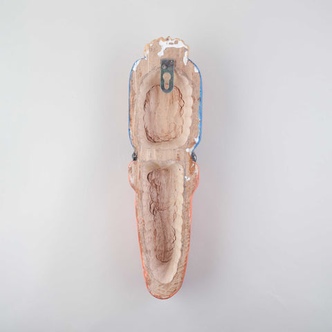 Back view of a handmade wooden Hanuman Gomira wall mask showing the carved wood construction and wall hanging arrangement