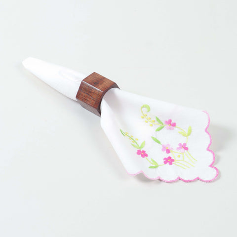 Handcrafted hexagon wooden napkin ring holding a table napkin for sophisticated dining table styling