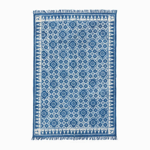 Handloom cotton dhurrie rug in indigo featuring geometric, floral hand block printed patterns across the surface
