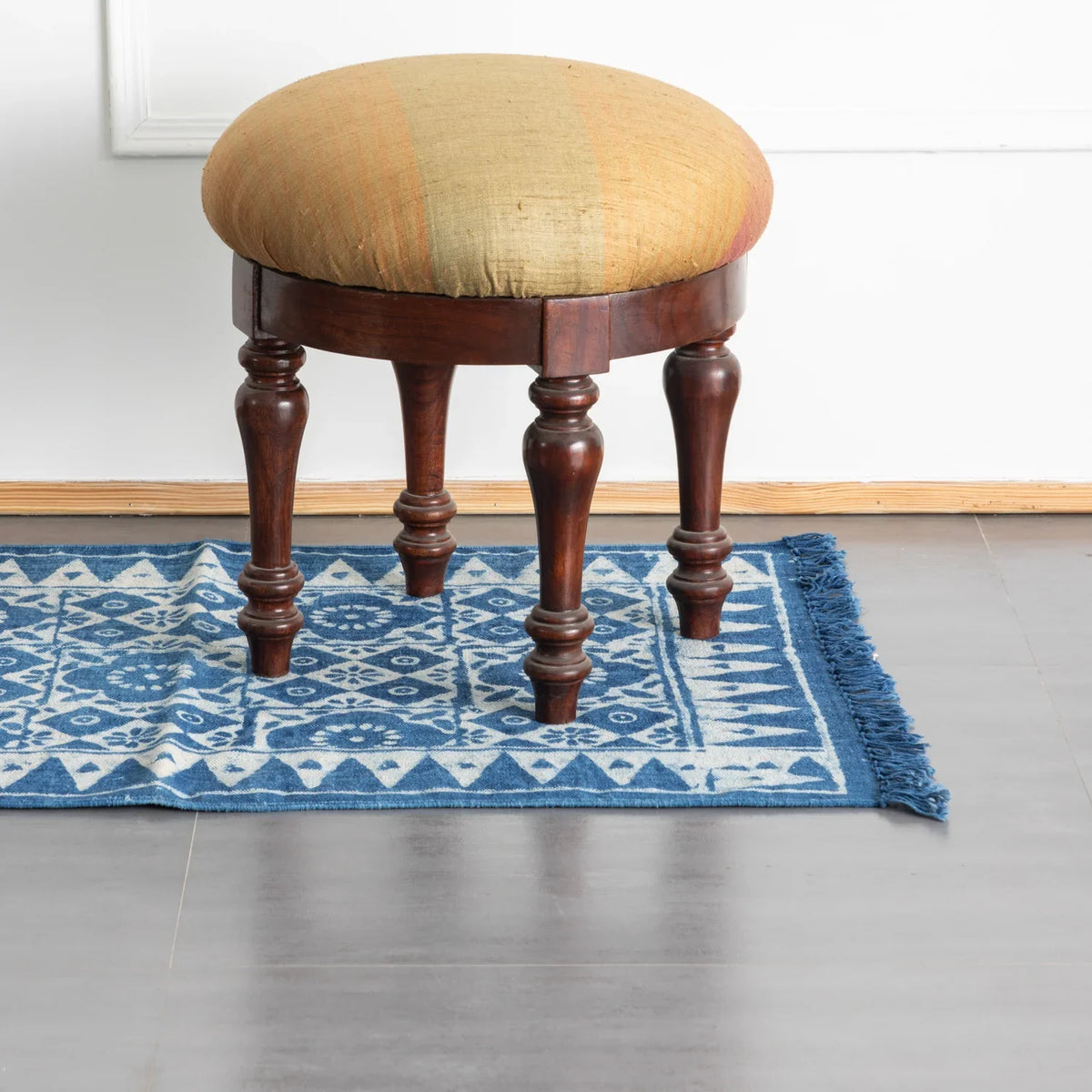 Hand block printed indigo dhurrie rug styled in a living room setting
