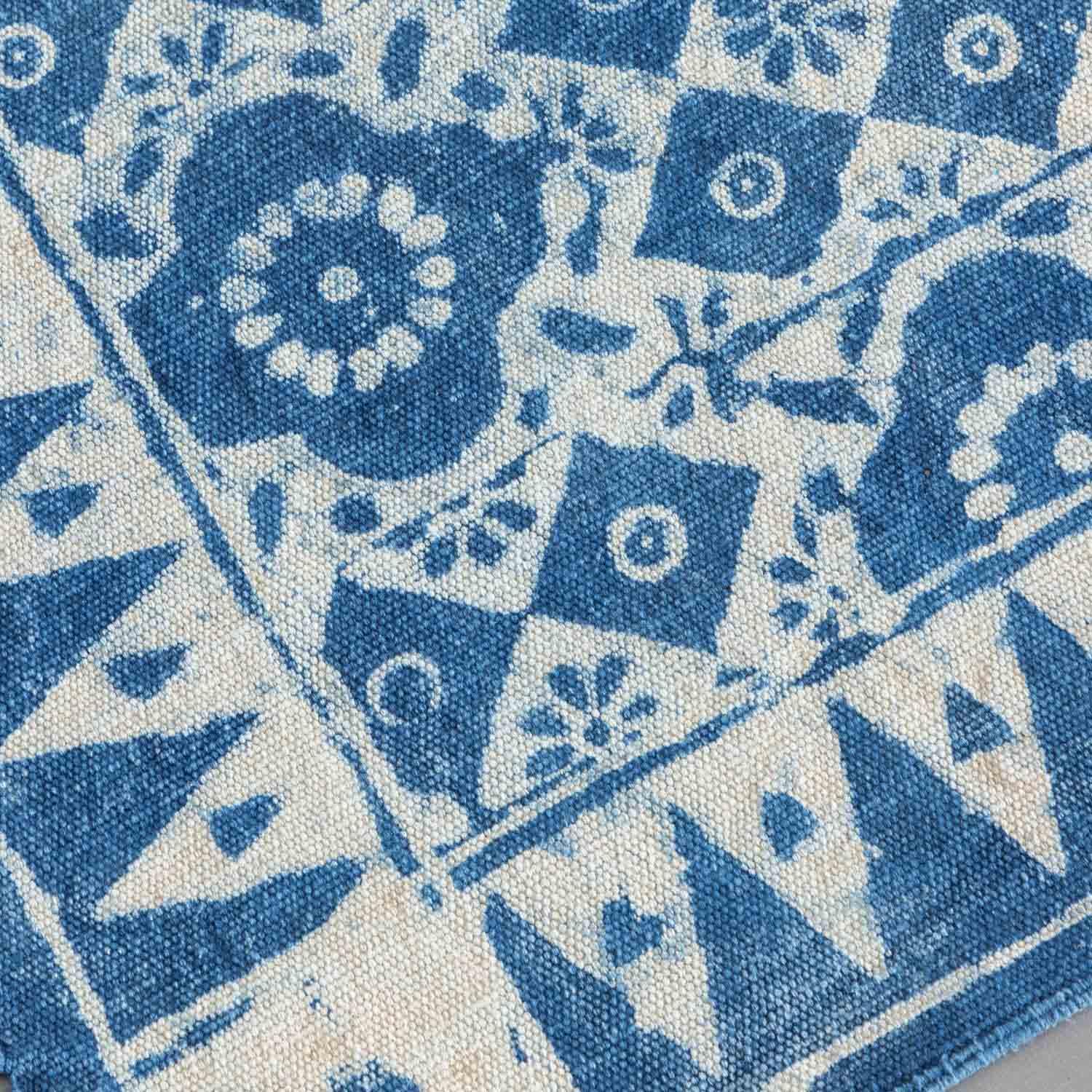 Close-up of handwoven cotton texture and craftsmanship on an indigo dhurrie rug