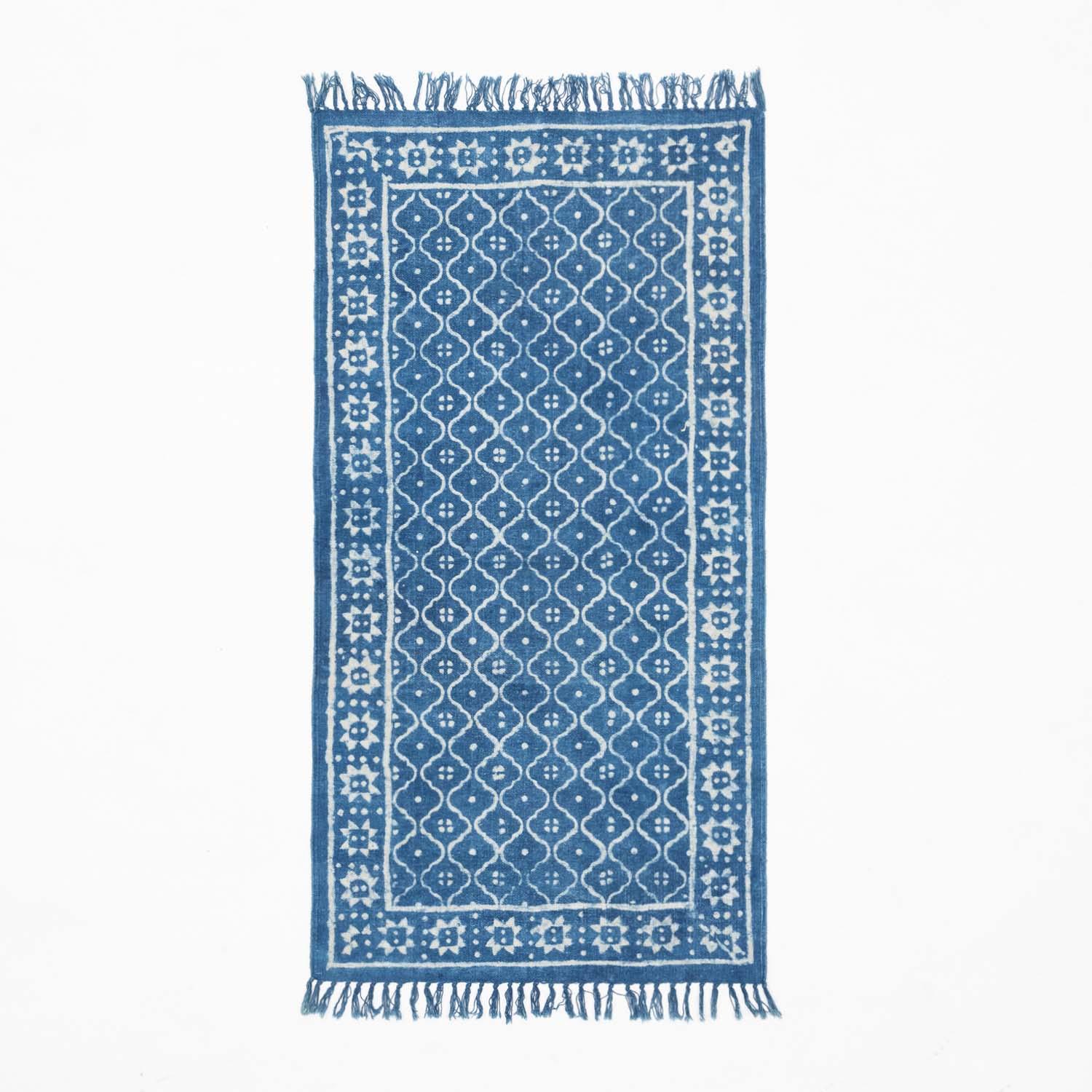 Handloom cotton dhurrie rug in indigo featuring trellis-inspired hand block printed patterns across the surface