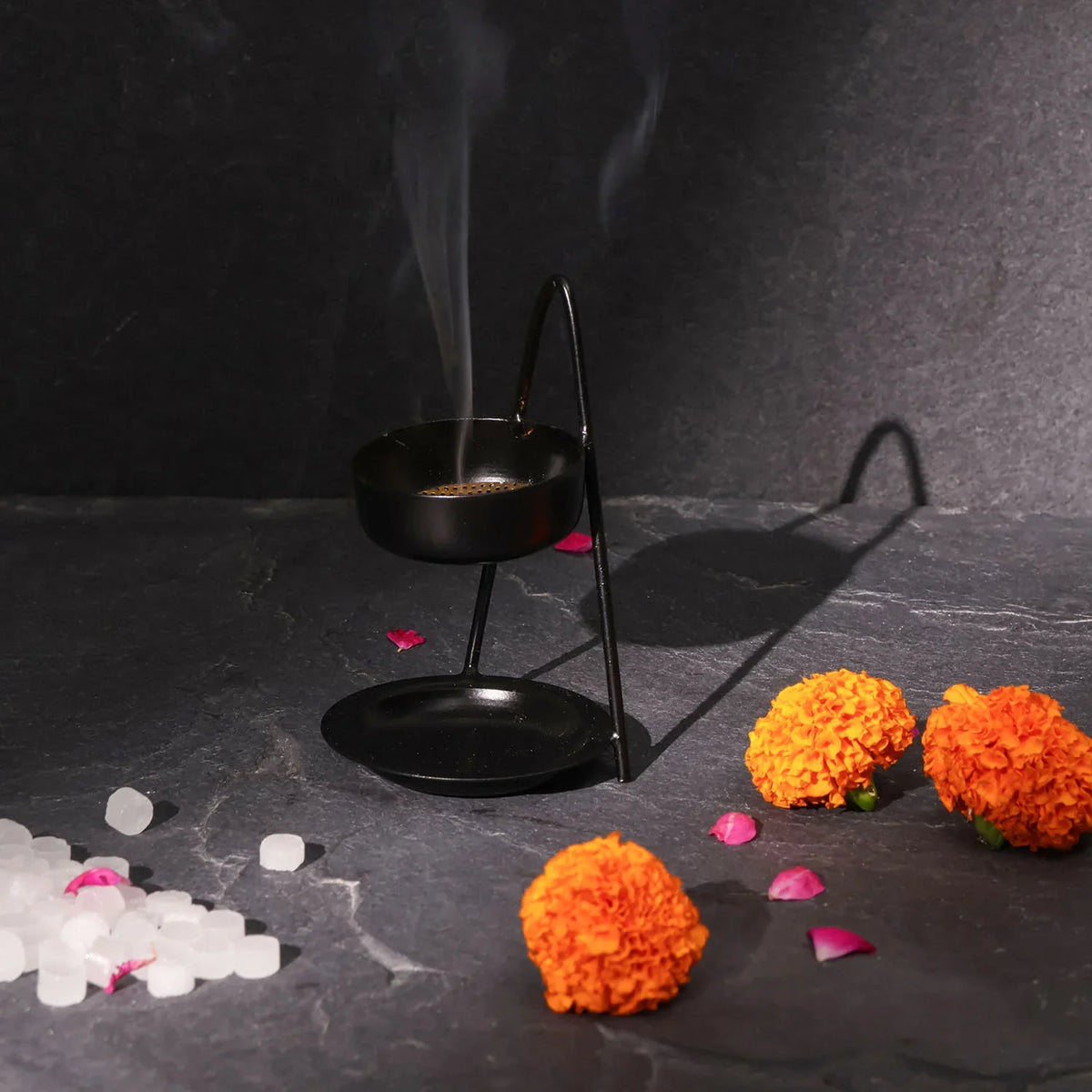 Handmade iron dhuni incense burner styled in a home temple for daily puja
