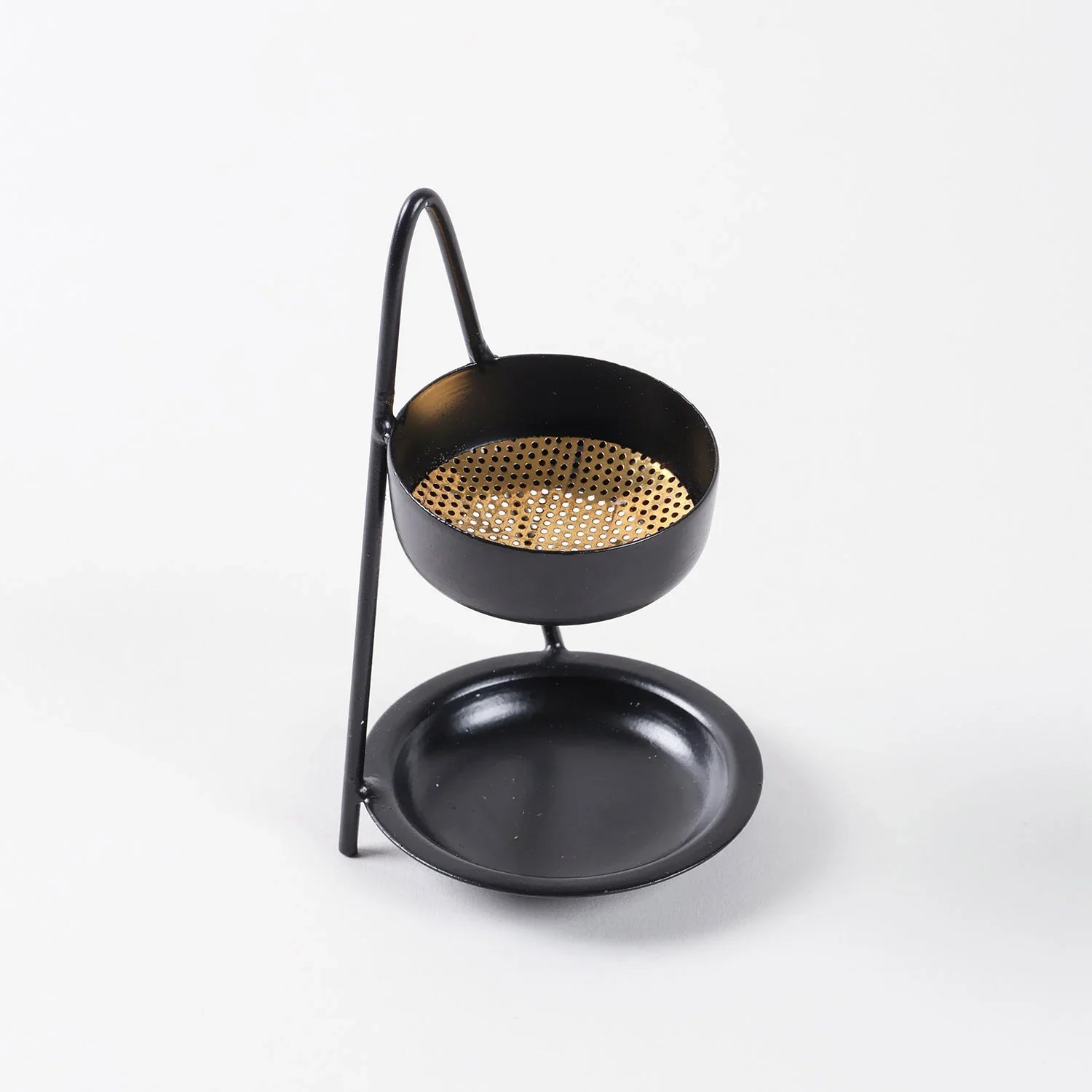 Top view of an iron dhuni incense burner with brass mesh