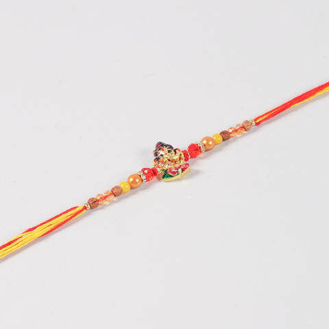 Close-up of the Handmade Kids Metal Ganesh Rakhi featuring the Bal Ganesh charm, crystal beads, gold-toned metal beads, and colourful thread