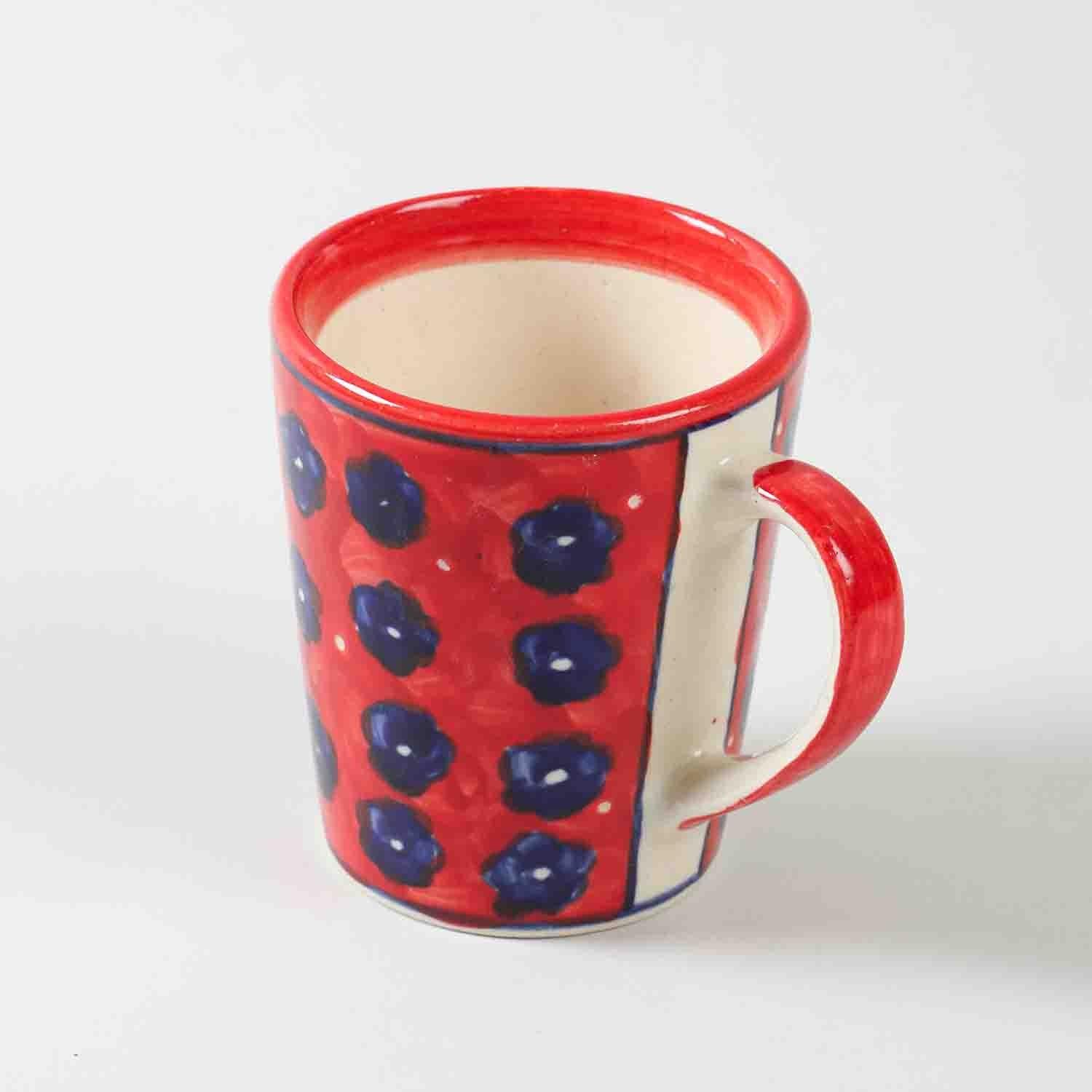 Front view of a large floral red hand-painted ceramic coffee mug showcasing decorative floral artwork