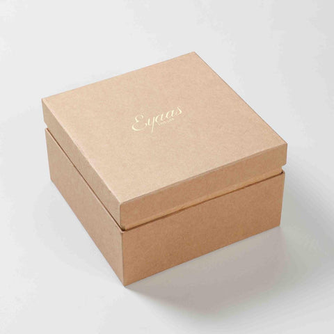 Angled view of a closed gift box containing a large floral red ceramic coffee mug gift set of 2
