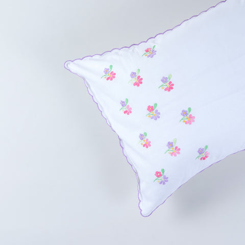 Close-up of handcrafted chikankari embroidery and scalloped edge detailing on cotton pillow cover