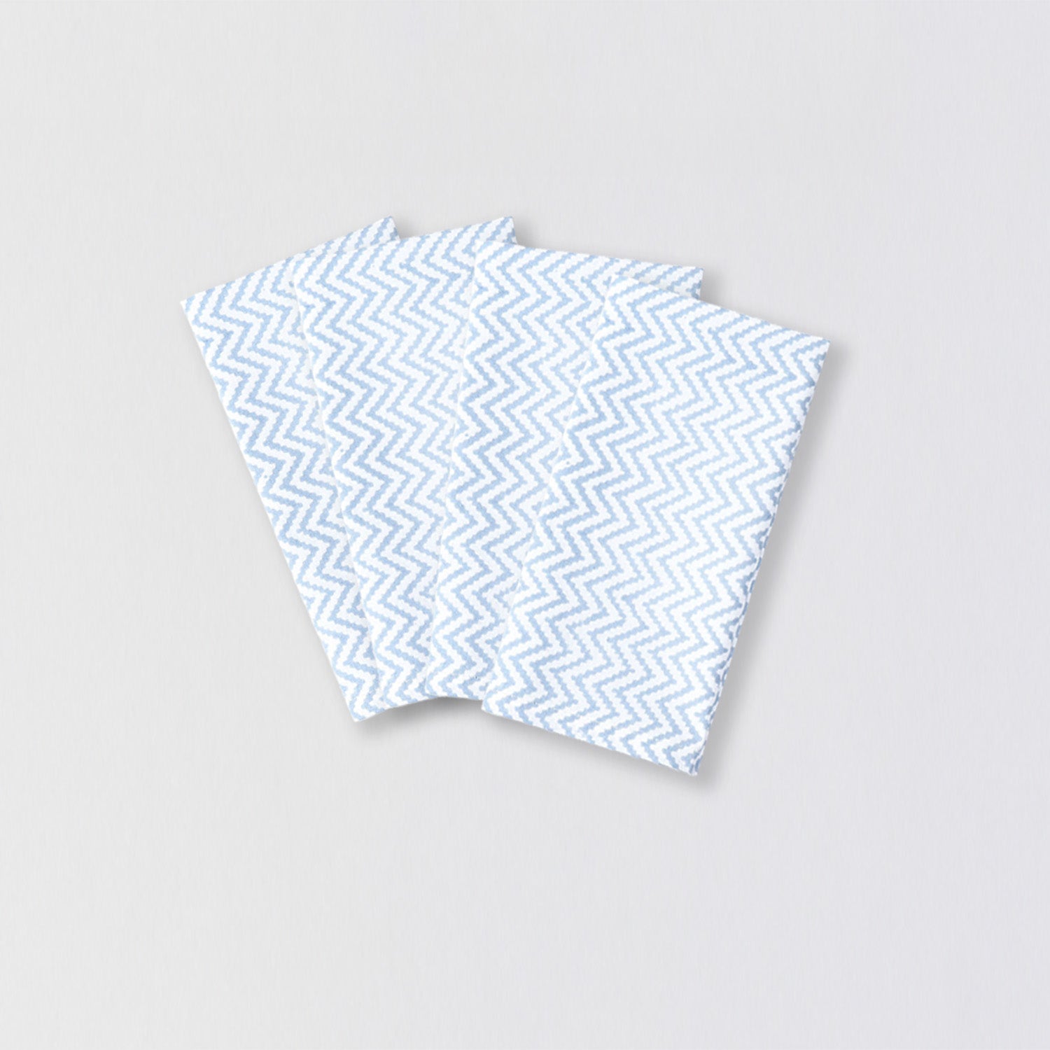 Set of four reusable cotton table linen napkins with light blue zigzag print design