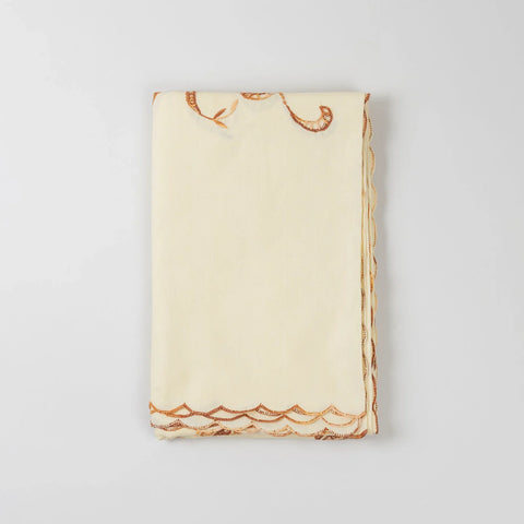 Folded light brown embroidered king-size bedcover showcasing fabric texture and handcrafted detailing