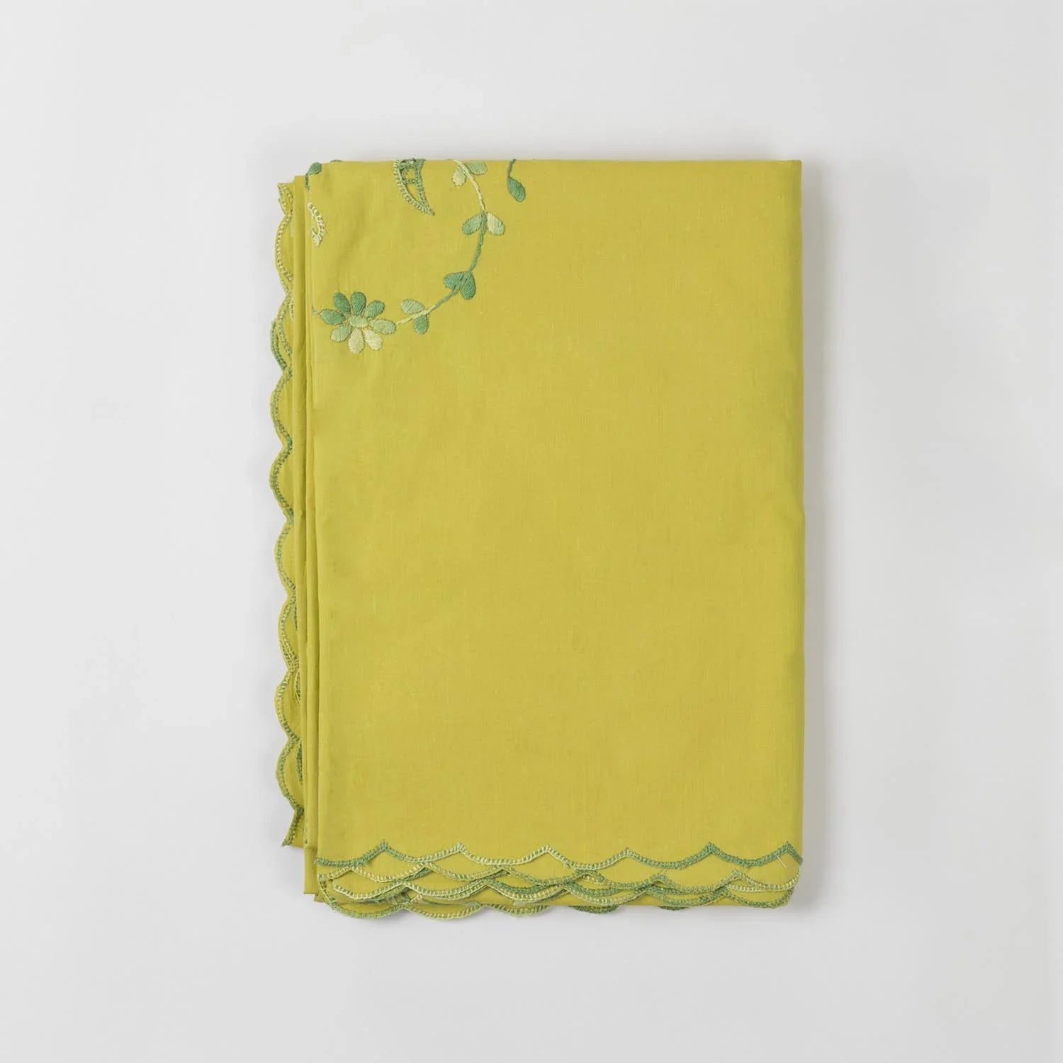 Folded light green cotton king-size bedcover showcasing floral chikankari embroidery and soft fabric texture