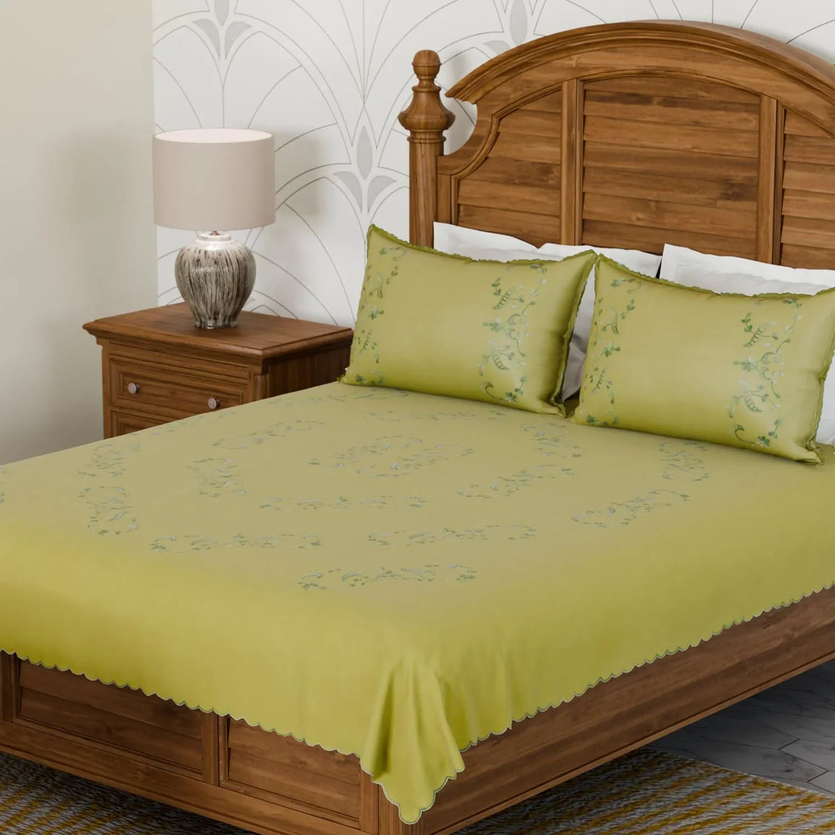 Light green cotton king size bedcover with floral chikankari embroidery and matching pillow cases styled in a serene bedroom