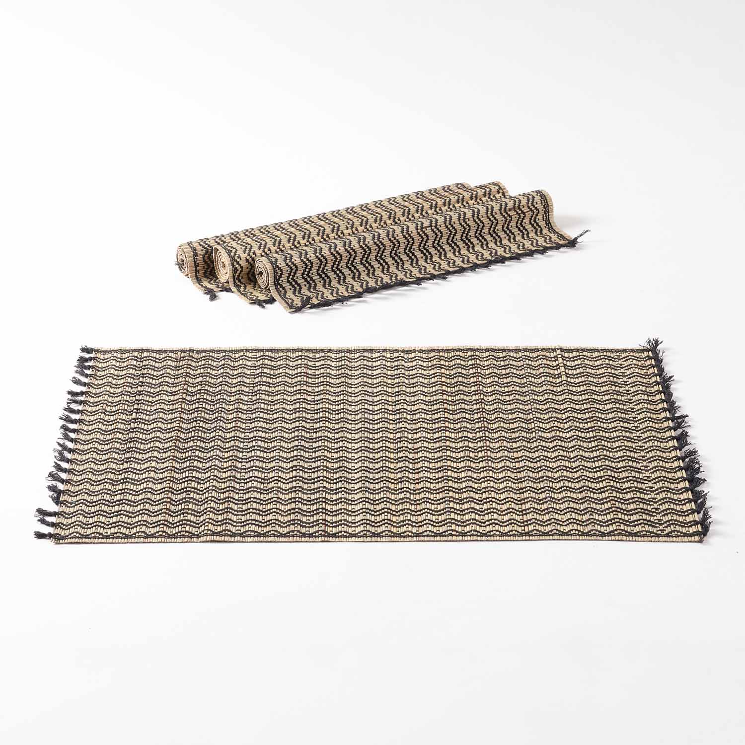 Natural fibre dining table placemats crafted from Madhurkathi grass, displayed as a dining table mat set of 4 with handwoven chevron patterns