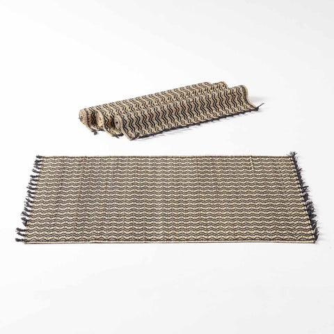 Natural fibre dining table placemats crafted from Madhurkathi grass, displayed as a dining table mat set of 4 with handwoven chevron patterns