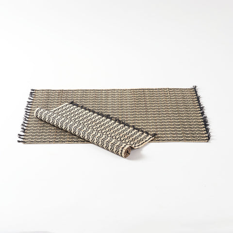 Handwoven Madhurkathi dining table placemats set crafted from natural river grass with black woven detailing