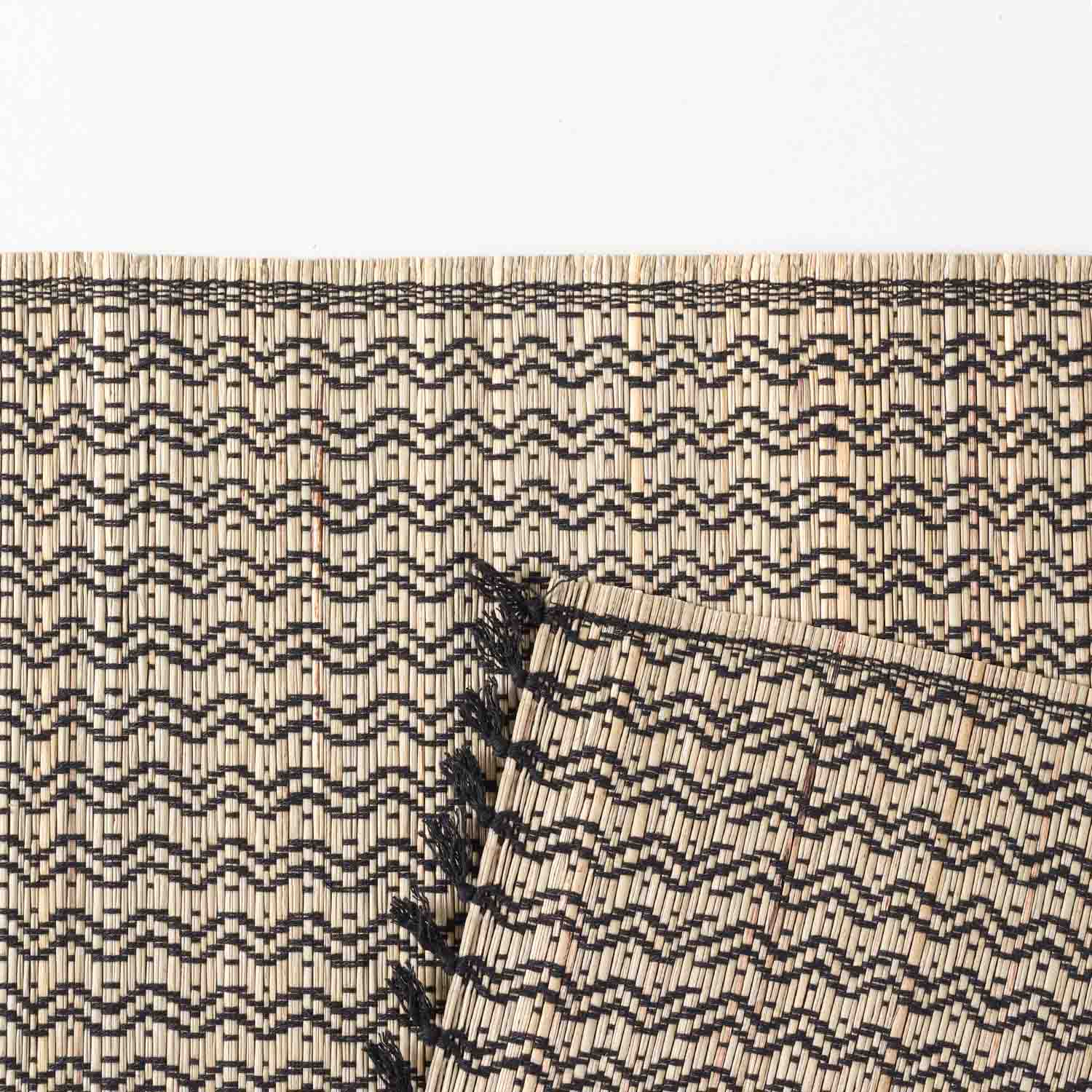 Detailed close-up of a handmade Madhurkathi  table placemats showcasing the dense natural fibre weave, geometric pattern, and durable black stitched border craftsmanship