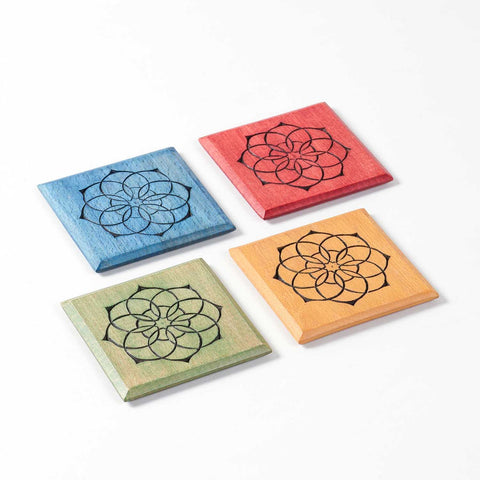 Angled view of the Mandala wooden coaster set of 4 showcasing the colourful handcrafted designs.