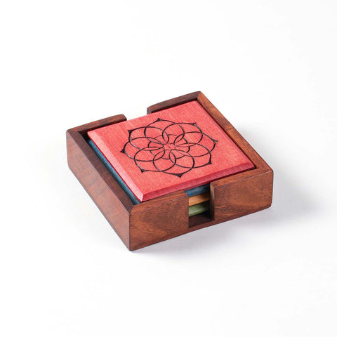 Angled view of the Mandala wooden coaster set of 4 with a matching holder for stylish table organisation