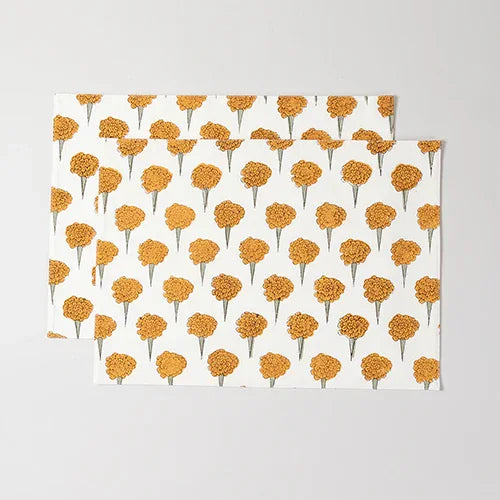 Set of 2 marigold hand block printed cotton placemats featuring yellow floral motifs on an off-white base