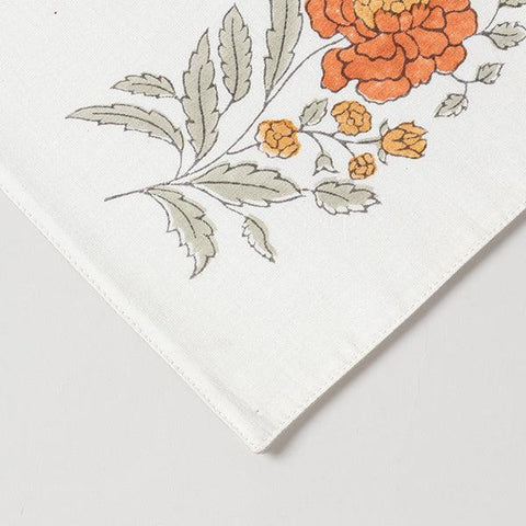 Close-up corner view of a marigold buta hand block printed Chanderi table runner, highlighting fabric texture and craftsmanship