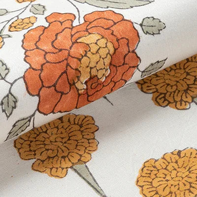 Macro view of yellow and green marigold buta block print motifs on a handcrafted Chanderi table