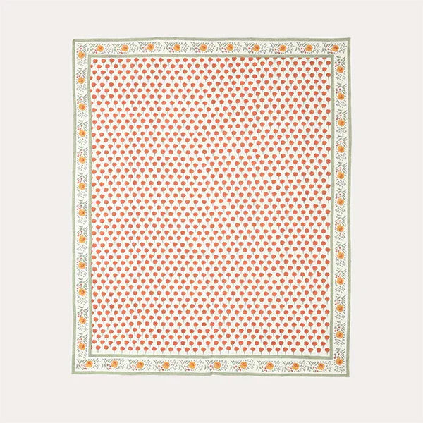 Full flat lay view of a king-size block-printed cotton bedcover with orange marigold buti motifs