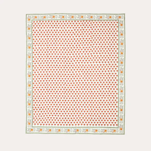 Full flat lay view of a king-size block-printed cotton bedcover with orange marigold buti motifs
