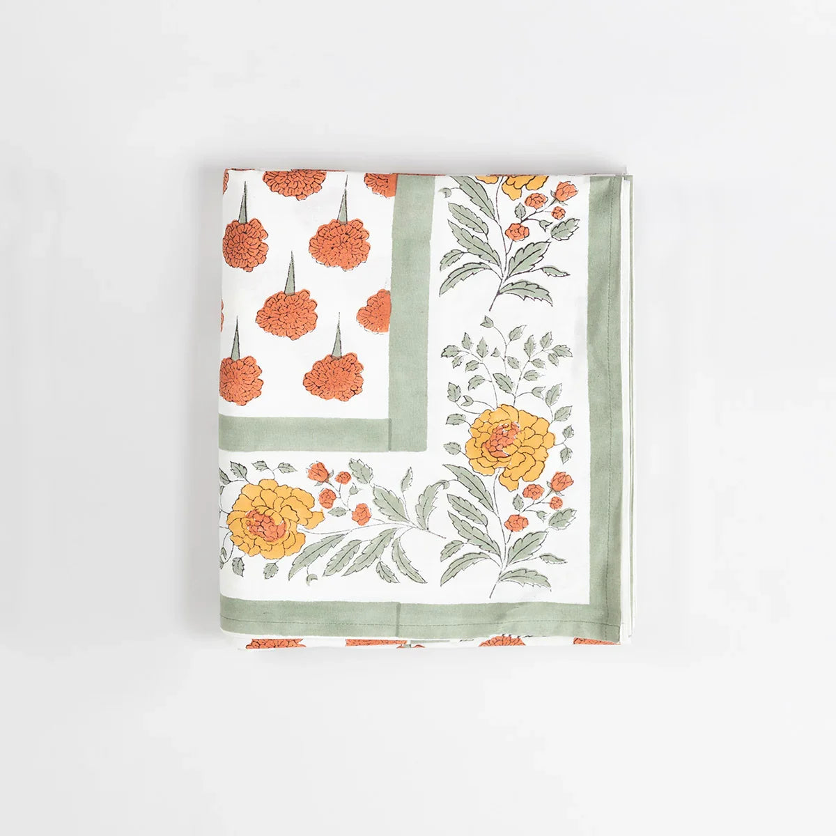 Folded cotton king bedcover showcasing orange marigold buti block printed patterns and fabric texture