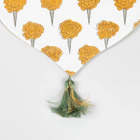 Close-up of the pointed V-shaped edge of a Marigold Buta Chanderi table runner finished with decorative tassels