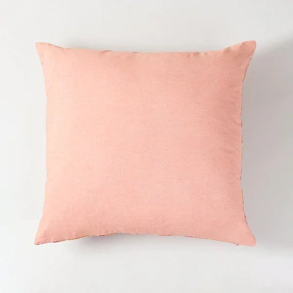 Back view of pink hand block printed cushion covers with floral design on the front and solid pink background on the back side