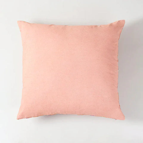 Back view of pink hand block printed cushion covers with floral design on the front and solid pink background on the back side