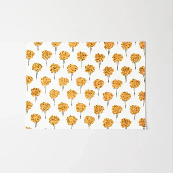 Full-size cotton placemat featuring yellow marigold floral block print design on an off white background