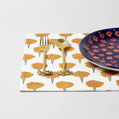 Single marigold block printed placemat styled with dinnerware for an elegant dining table decor