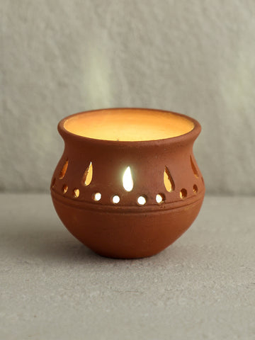 Individual handcrafted terracotta matka diya tea-light holder styled and lit 
