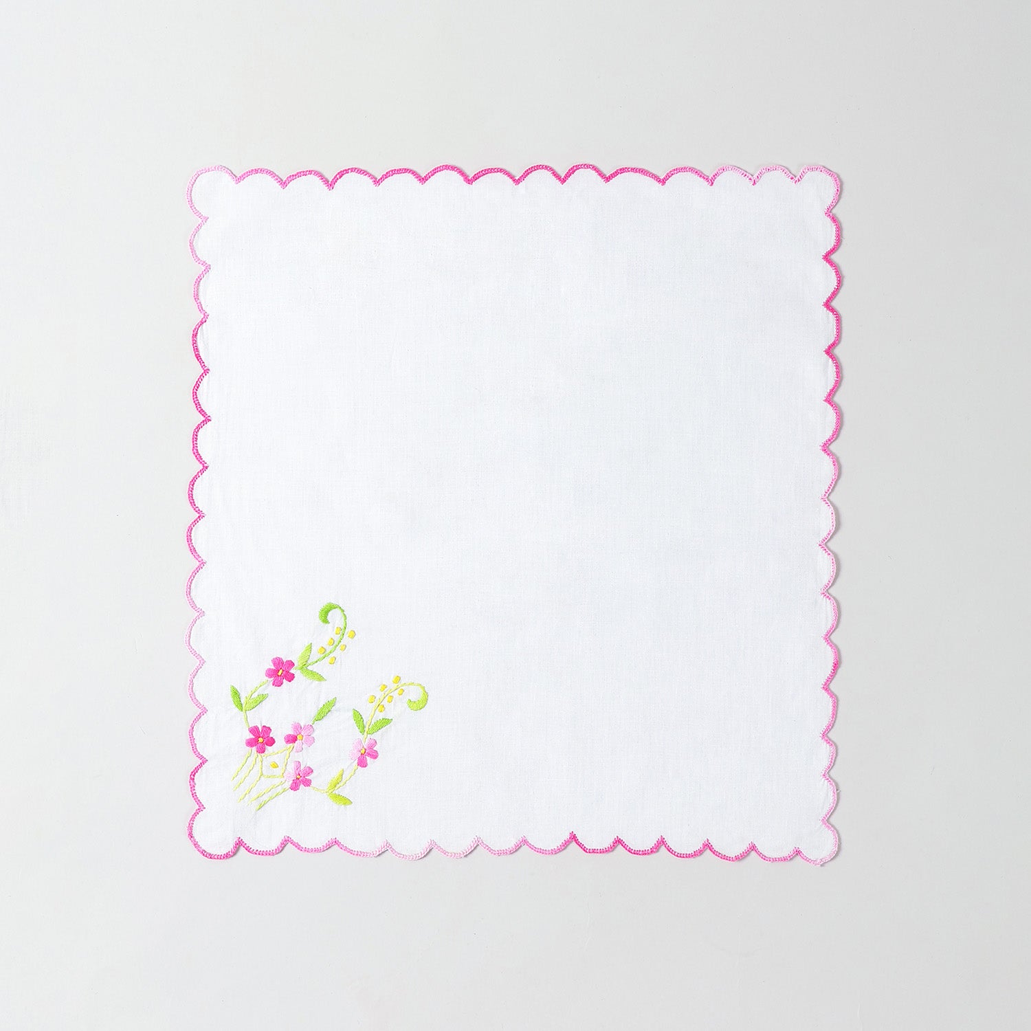 White cotton table napkin with multicolour floral hand embroidery crafted using traditional Bengal chikankari techniques