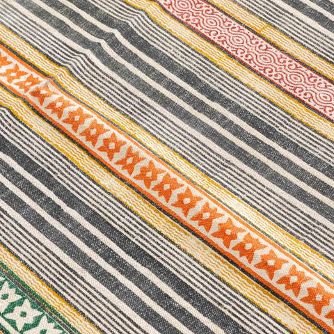 Close-up of geometric stripe motifs highlighting handloom weaving texture and block printed craftsmanship