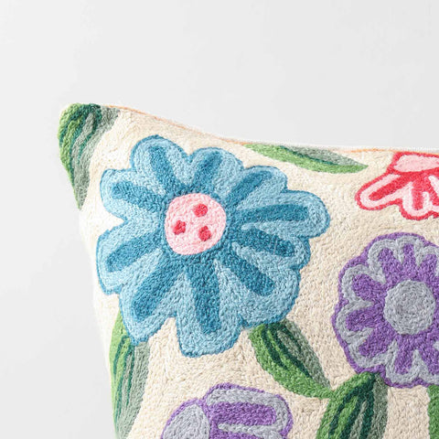 Close-up of colourful floral crewel embroidery highlighting textured wool threads and intricate handcrafted detailing
