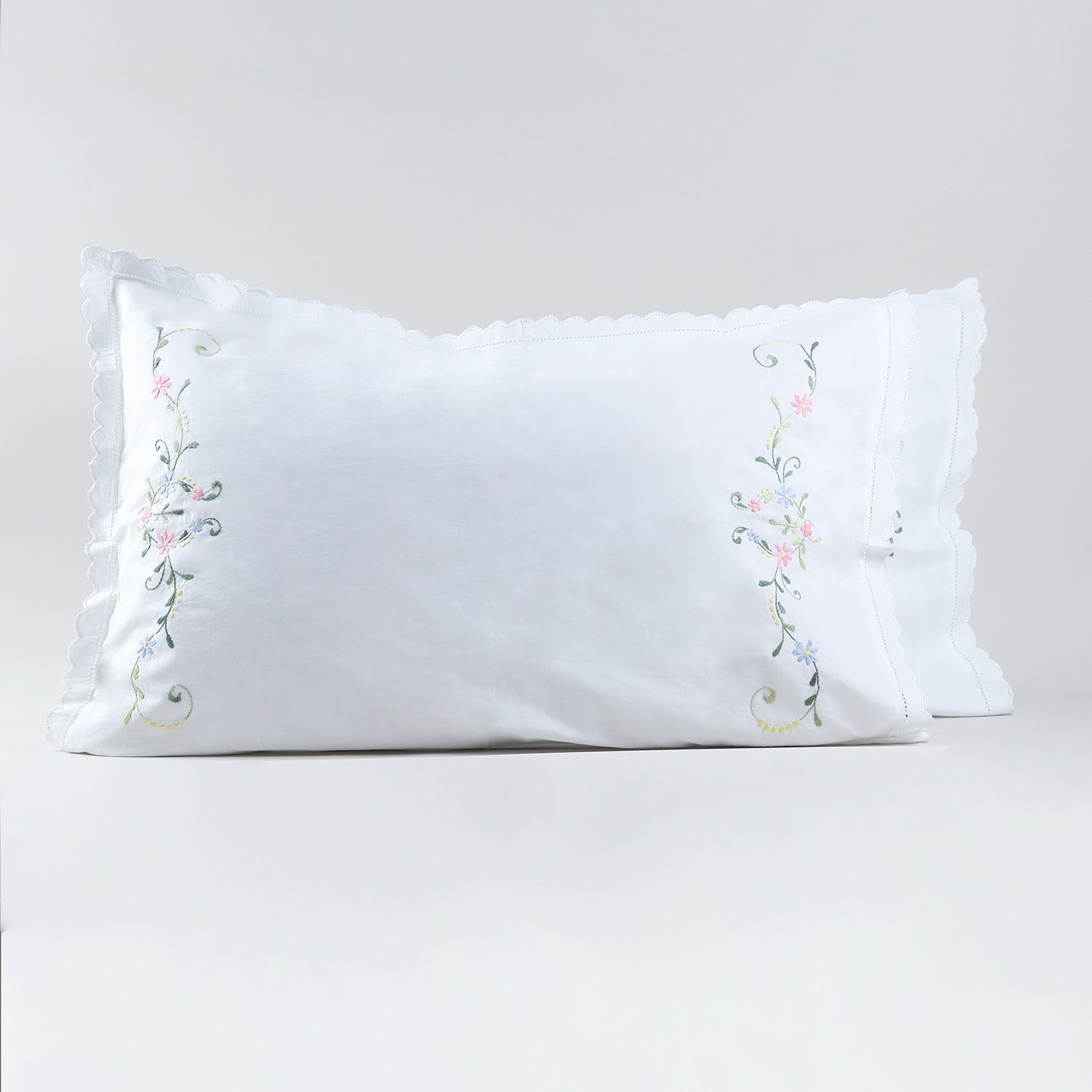 Set of two white cotton pillow cases featuring delicate multicoloured floral Bengal chikankari embroidery